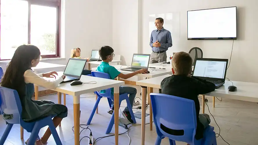 Students using computers in a classroom.